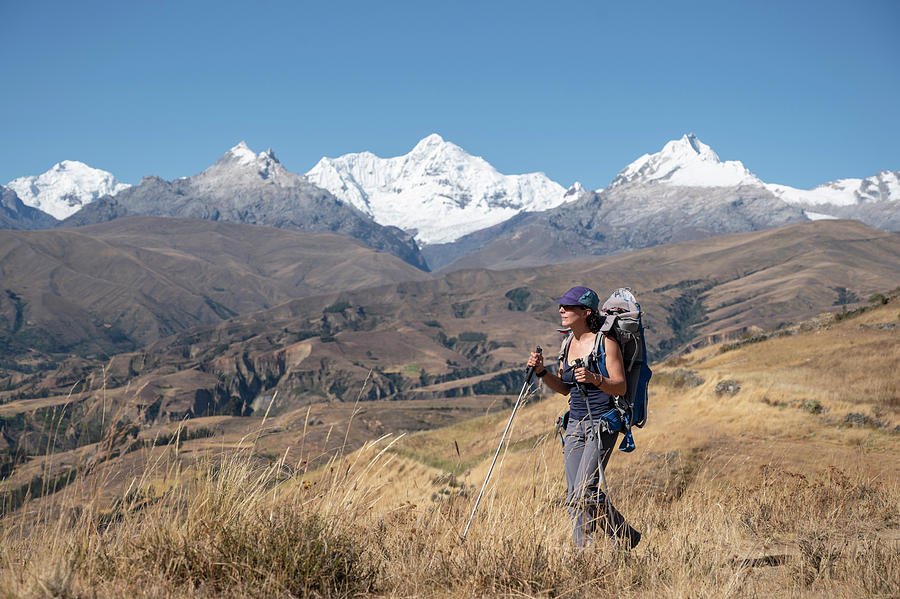 Woman hiker with backpack hiking in Cordillera Blanca, Peru, A