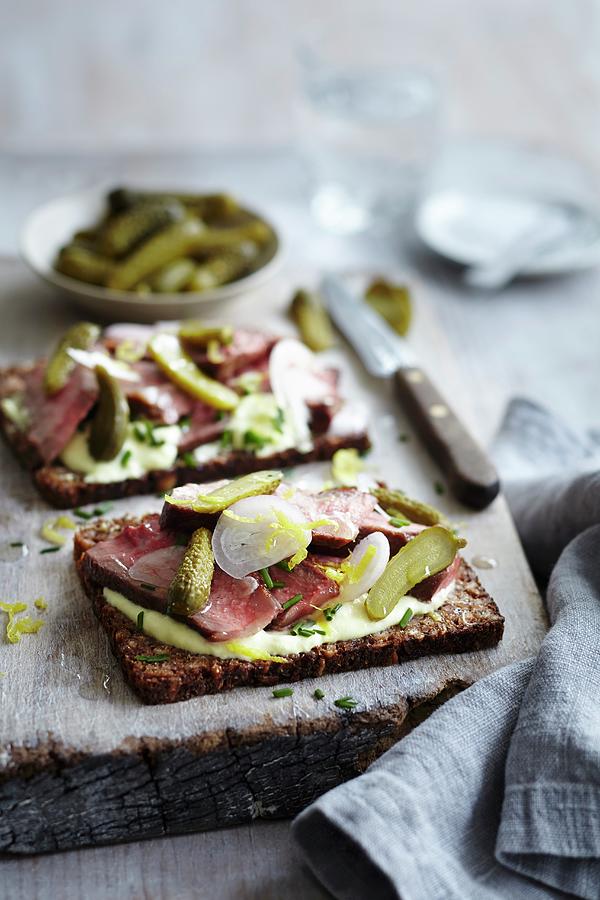 Open Rye Bread Sandwiches Topped With Beef, Gherkins, Pickled Onions And Chives Photograph by Charlotte Tolhurst