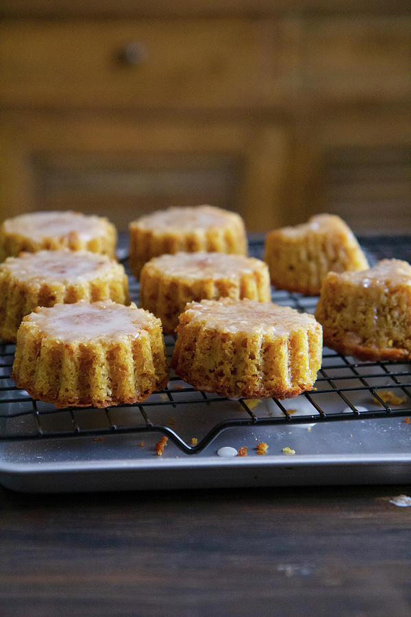 Orange And Almond Cakes On A Cooling Rack Photograph by Patricia Miceli