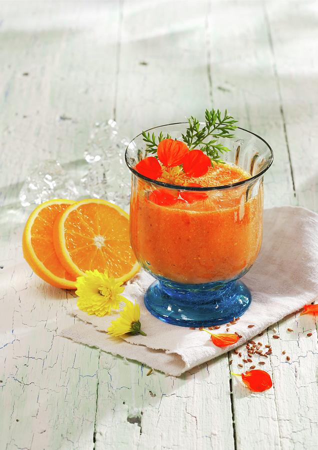 Orange And Peach Smoothie With Carrot Juice, Orange Juice And Ginger Photograph by Karl Newedel