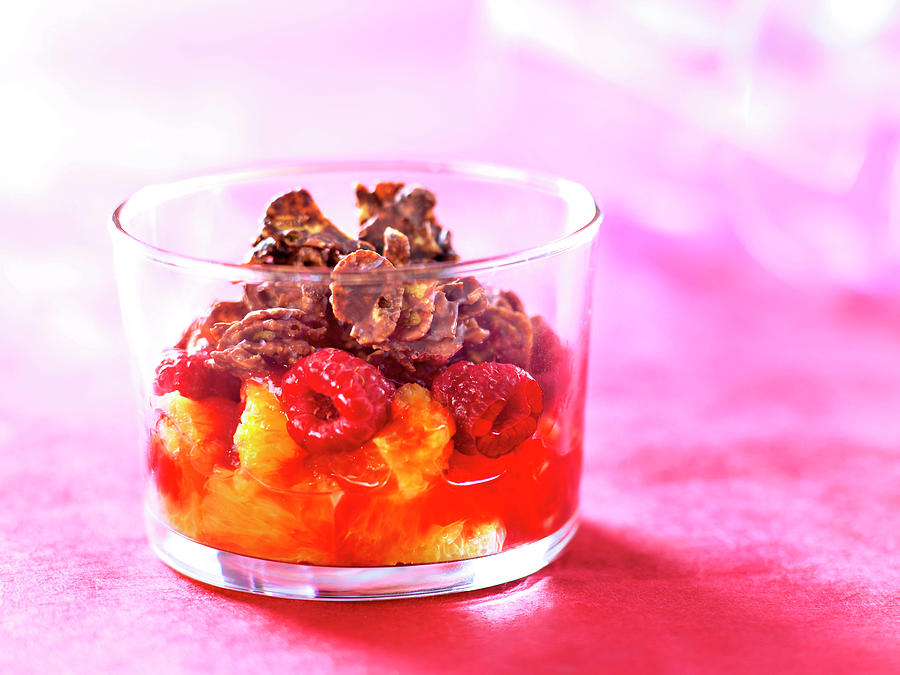 Orange And Raspberry Fruit Salad Topped With Chocolate Coated Cornflakes Photograph by Nicolas Edwige
