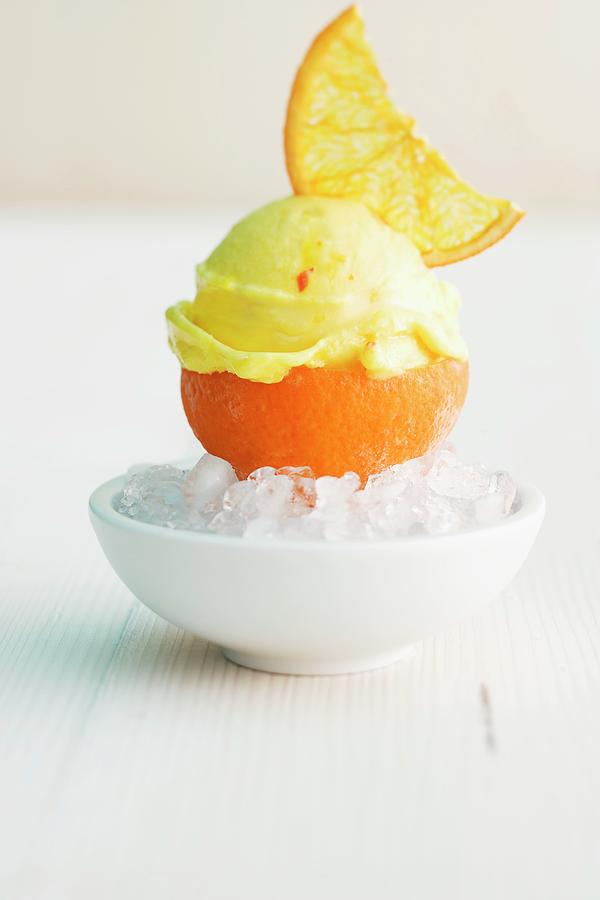 Orange And Saffron Ice Cream Served In An Orange Skin Photograph by Michael Wissing
