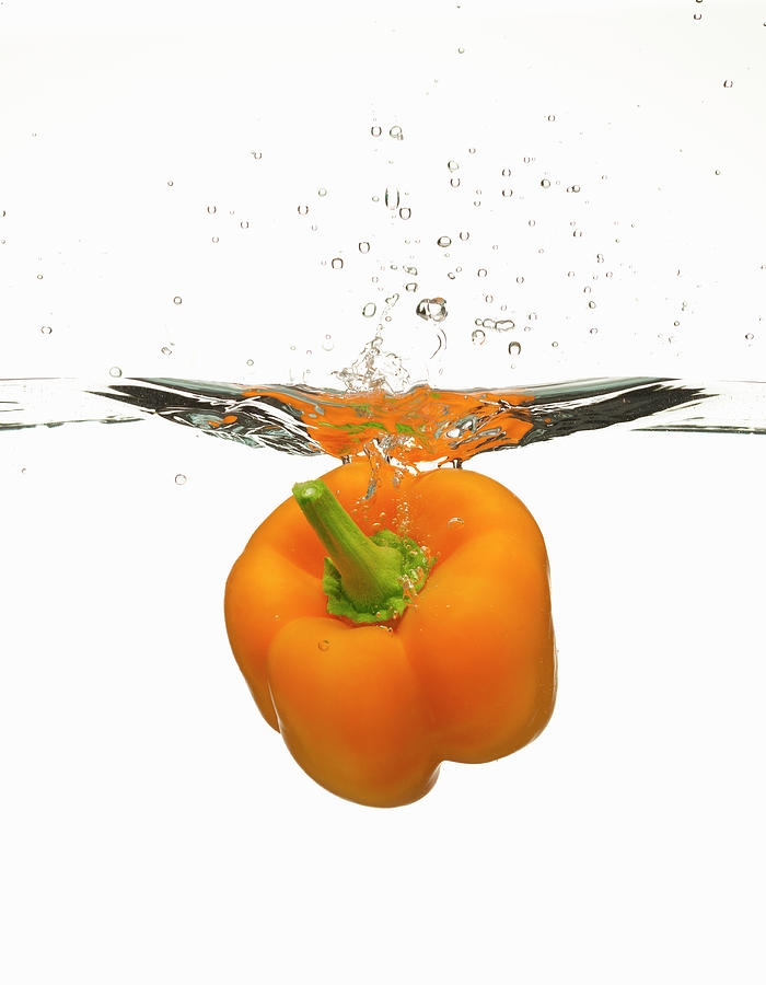 Orange Bell Pepper Splashing Photograph by Don Farrall