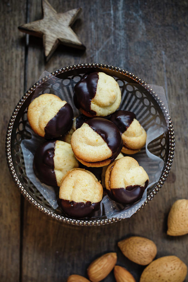 Orange Cookies Filled With Jam And Dipped In Chocolate Photograph by Brigitte Sporrer