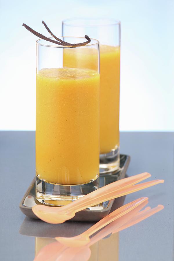 Orange Drinks With Vanilla Pods Photograph by Uwe Bender