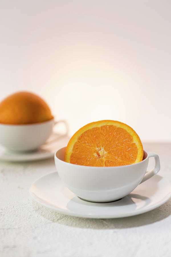 Orange Halves In White Cups Photograph by Katrin Benary