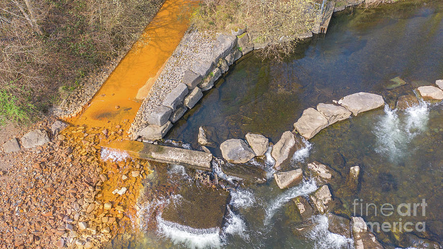 Orange Iron Oxide Staining In Stream by Andy Davies/science Photo Library