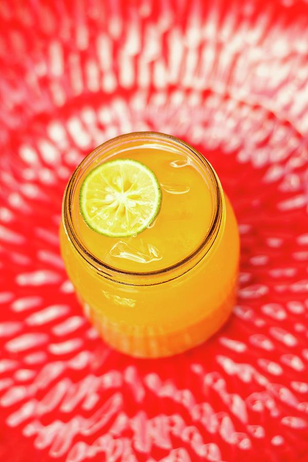 Orange Juice With Turmeric And A Slice Of Lime Photograph by Elle Brooks