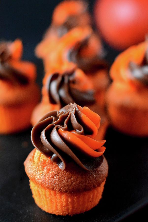 Orange Muffins With A Chocolate And Orange Frosting Photograph by Dorota Piekarska