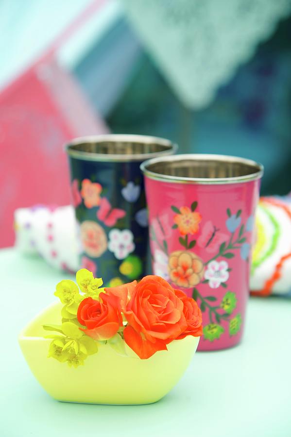 Orange Roses In Yellow Bowl In Front Of Floral Beakers Photograph by Winfried Heinze