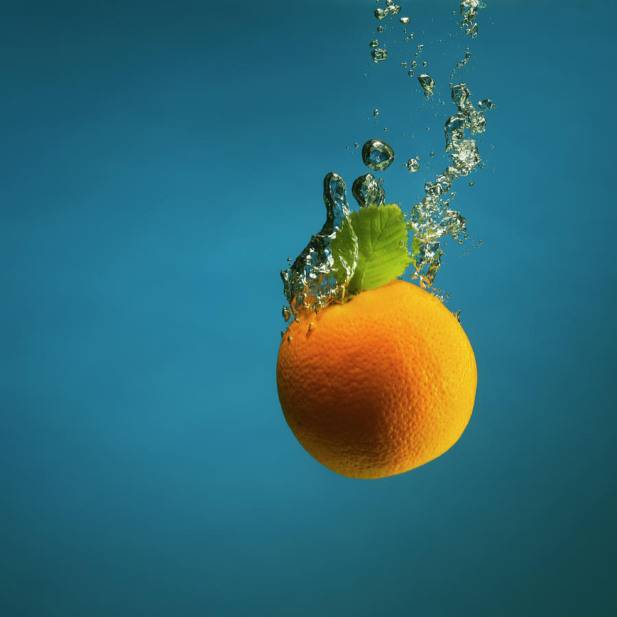 Orange Splashed Into Water Photograph by Henrik Sorensen