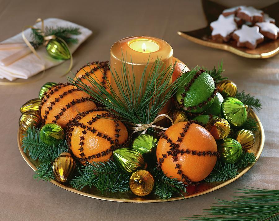 Oranges And Limes Studded With Cloves, Fir Sprigs & Candle Photograph by Strauss, Friedrich