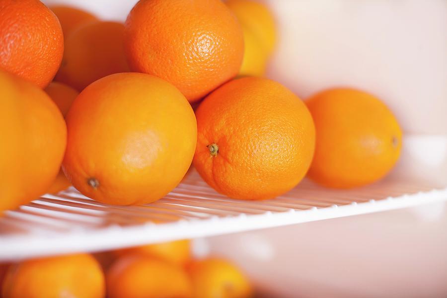 Oranges In A Fridge Photograph by Nika Moskalenko