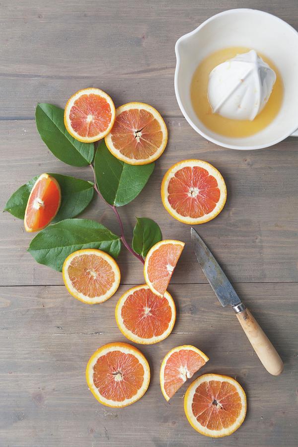 Oranges With A Citrus Press Photograph by Debra Cowie