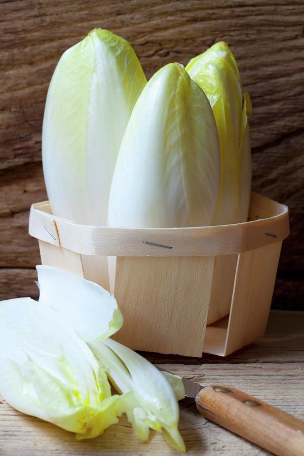 Organic Chicory In A Wooden Basket Photograph by Hilde Mche