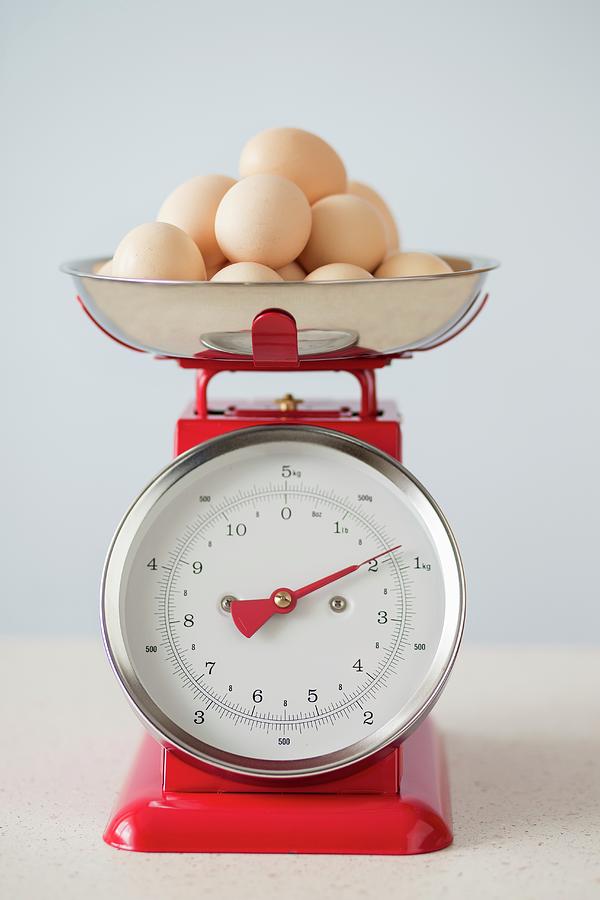 Organic Eggs On Pair Of Red Vintage Kitchen Scales Photograph by Malgorzata Laniak