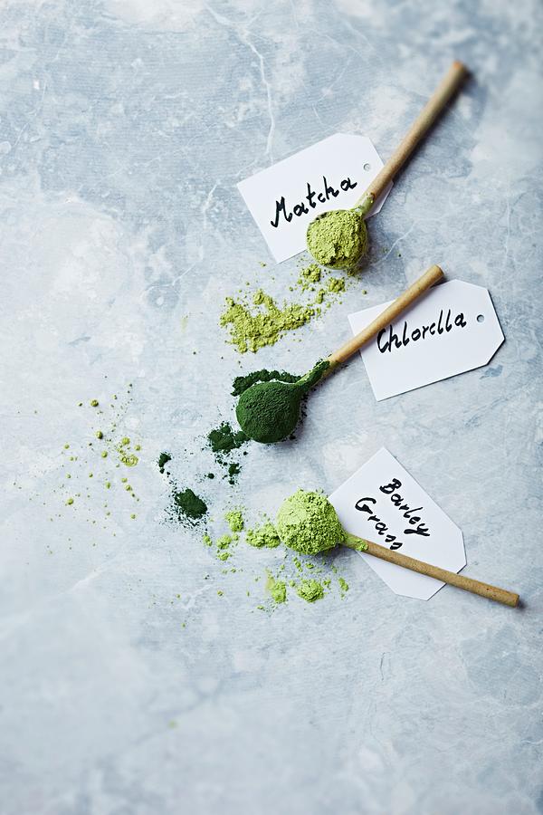 Organic Matcha, Chlorella And Barley Grass On Ceramic Spoons Photograph by B.&.e.dudzinski