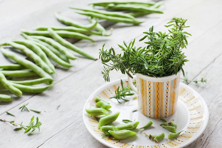 Organic Savory In A Vintage Cup On A Plate And Organic Beans On A Wooden Surface Photograph by Sabine Lscher