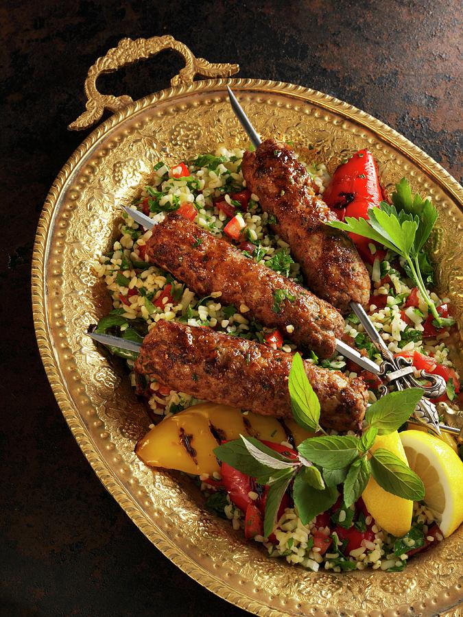 Oriental Minced Lamb Skewers On A Bed Of Tabbouleh Photograph by Karl Newedel