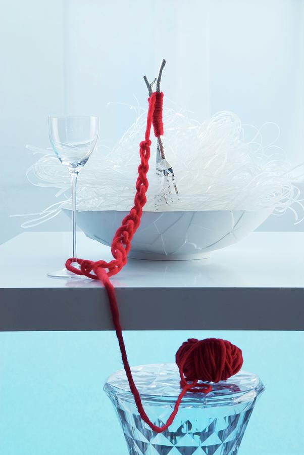 Oriental Place Setting: Forks In Bowl Of Glass Noodles Bound With Red Woollen Yarn Photograph by Matteo Manduzio