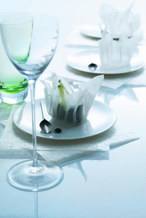 Oriental Place Settings: Rice Paper Bowls On Plates Behind Stemware Glass Photograph by Matteo Manduzio
