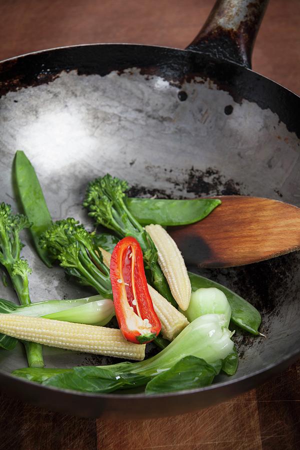 Oriental Vegetables And A Spatula In A Wok Photograph by Richard Church