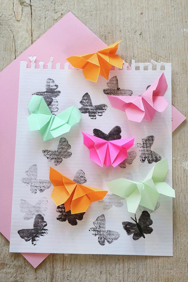 Origami Butterflies On Printed Paper Photograph by Regina Hippel