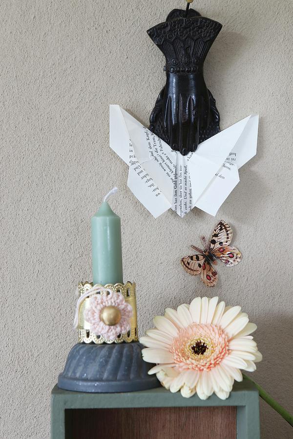 Origami Butterfly Held In Clip Above Gerbera Daisy And Candle Photograph by Regina Hippel