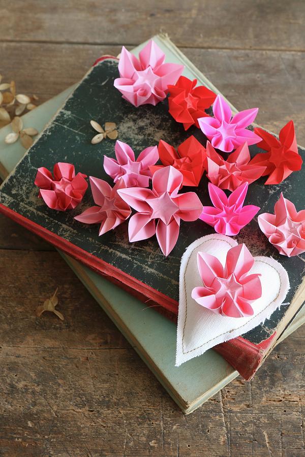 Origami Flowers In Various Shades Of Red And Pink On Old Books Photograph by Regina Hippel