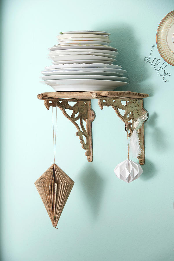 Origami Pendant Hung From Wall Bracket Holding Stack Of Plates Photograph by Inge Ofenstein