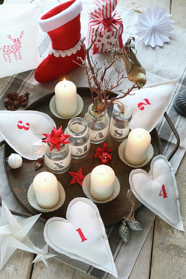 Original Advent Arrangement Made From Numbered Fabric Hearts On Wooden Tray, Paper Stars, Christmas Stocking And Jars With Fabric Lettering Photograph by Regina Hippel