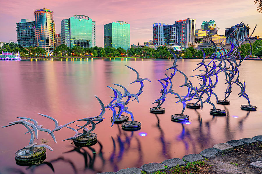 Orlando Skyline Photograph - Orlando Skyline and Take Flight Sculptures at Sunset by Gregory Ballos