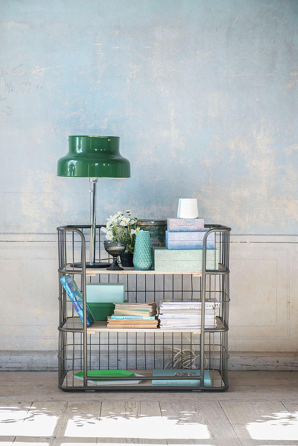 Ornaments In Shades Of Blue And Green On Metal Shelves Against Distressed Wall Photograph by Magdalena Bjrnsdotter