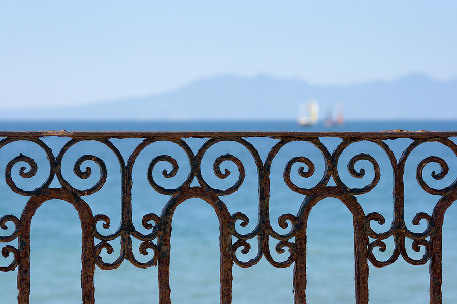 Ornate Ironwork Railing With Ocean View Photograph by Yangyin