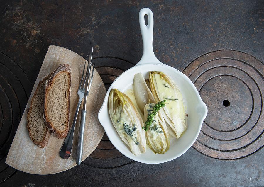 Oven-baked Chicory With Roquefort With Thai Green Pepper And Country Bread On A Wooden Board Photograph by Angelika Grossmann