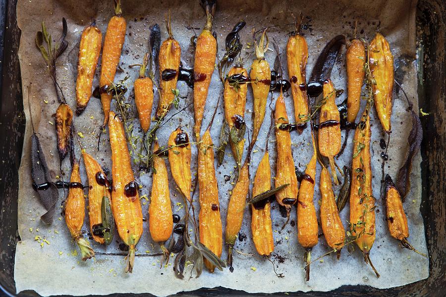 Oven Cooked Carrots With Herbs And Sauce On A Baking Sheet top View Photograph by Galya Ivanova