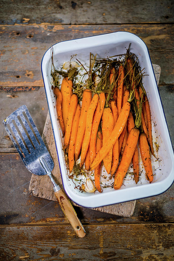 Oven Roasted Baby Carrots In A Dish Photograph by Sebastian Schollmeyer