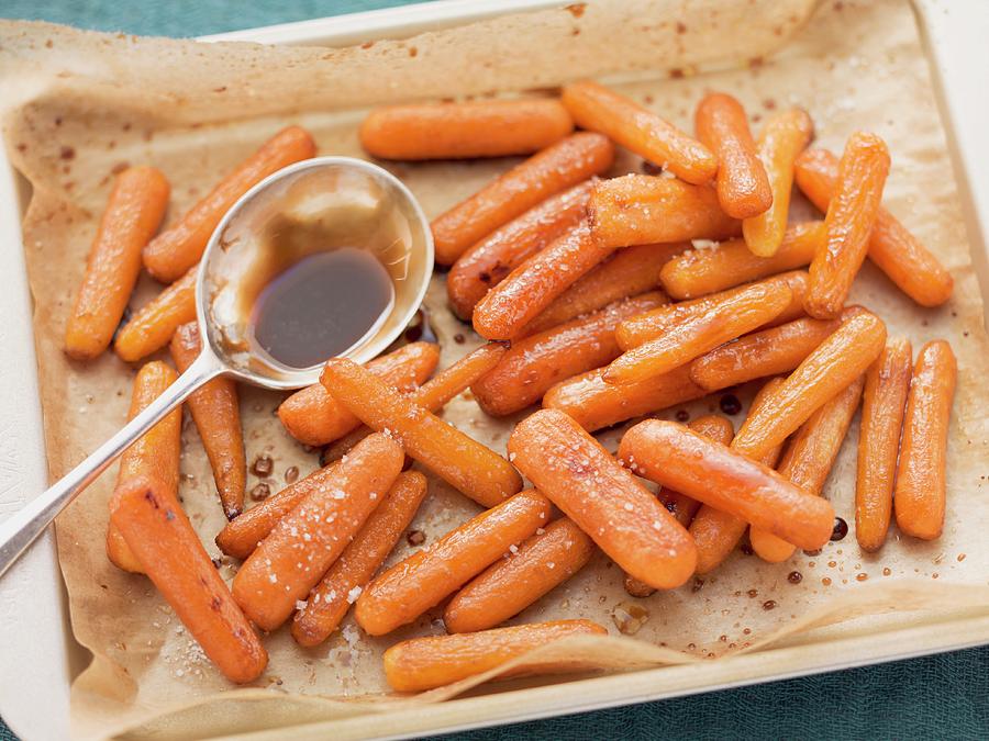 Oven-roasted Baby Carrots With Balsamic Vinegar, On The Baking Tray Photograph by Eising Studio - Food Photo & Video
