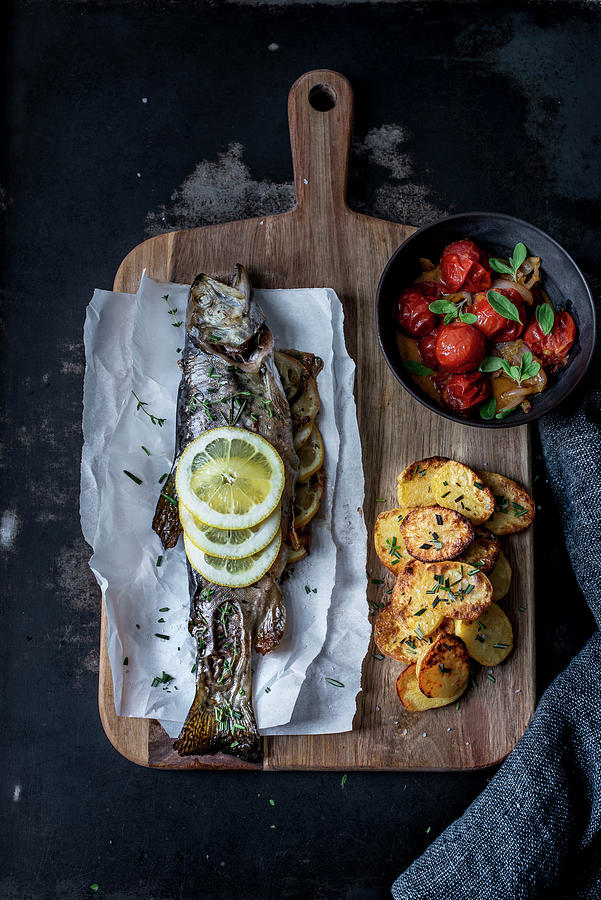 Oven-roasted Brook Trout With Baked Potatoes And Tomato And Onion Sauce Photograph by Carolin Strothe