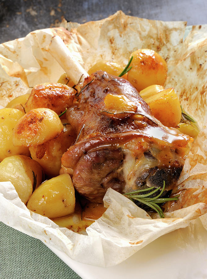 Oven-roasted Knuckle Of Lamb With Potatoes And Rosemary Photograph by Franco Pizzochero