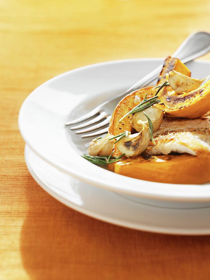 Oven-roasted Pumpkin And Garlic With Fish Photograph by Martin Dyrlv