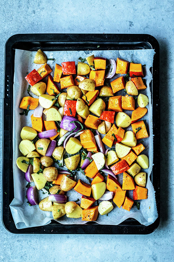 Oven-roasted Pumpkin And Potatoes Photograph by Simone Neufing