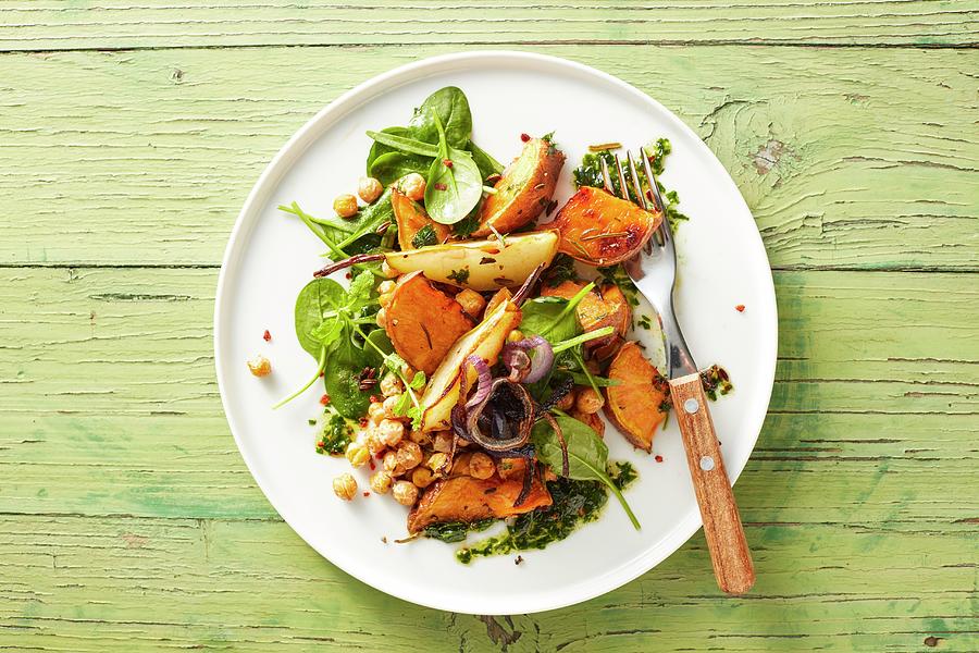 Oven Roasted Vegan Vegetables With Sweet Potatoes, Pears, Chickpeas And Herb Pesto Photograph by Kai Schwabe