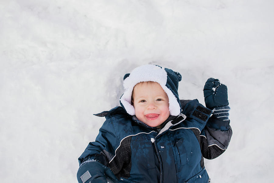 Overhead Portrait Of Cute Baby Boy Lying On Snow Photograph by Cavan ...