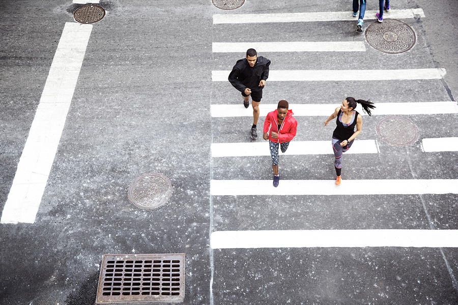 Overhead View Of Athletes Running On Zebra Crossing Photograph by Cavan ...