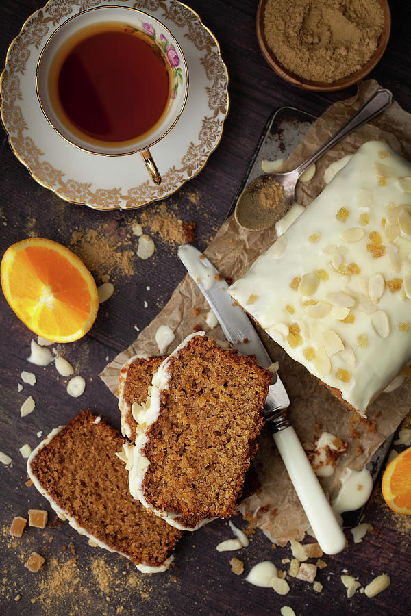 Overhead View Of Sliced Vegan Orange And Ginger Cake With Glace Icing Photograph by Jane Saunders