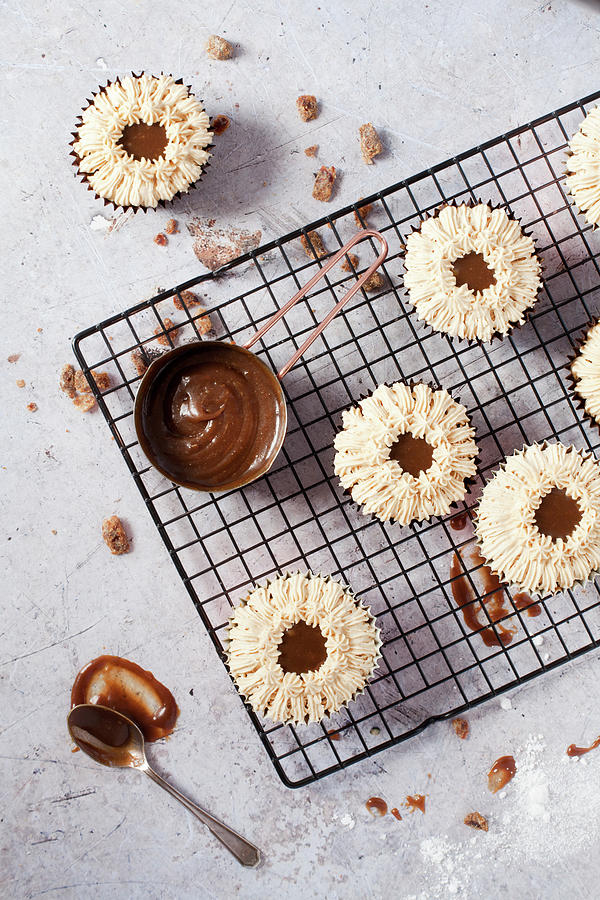 Overhead View Of Sticky Toffee Cupcakes On A Cooling Rack Photograph by Jane Saunders