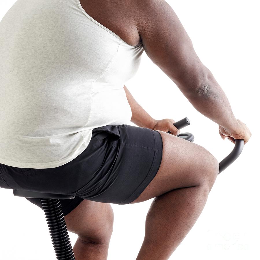 Overweight Man On An Exercise Bike Photograph by Science Photo Library