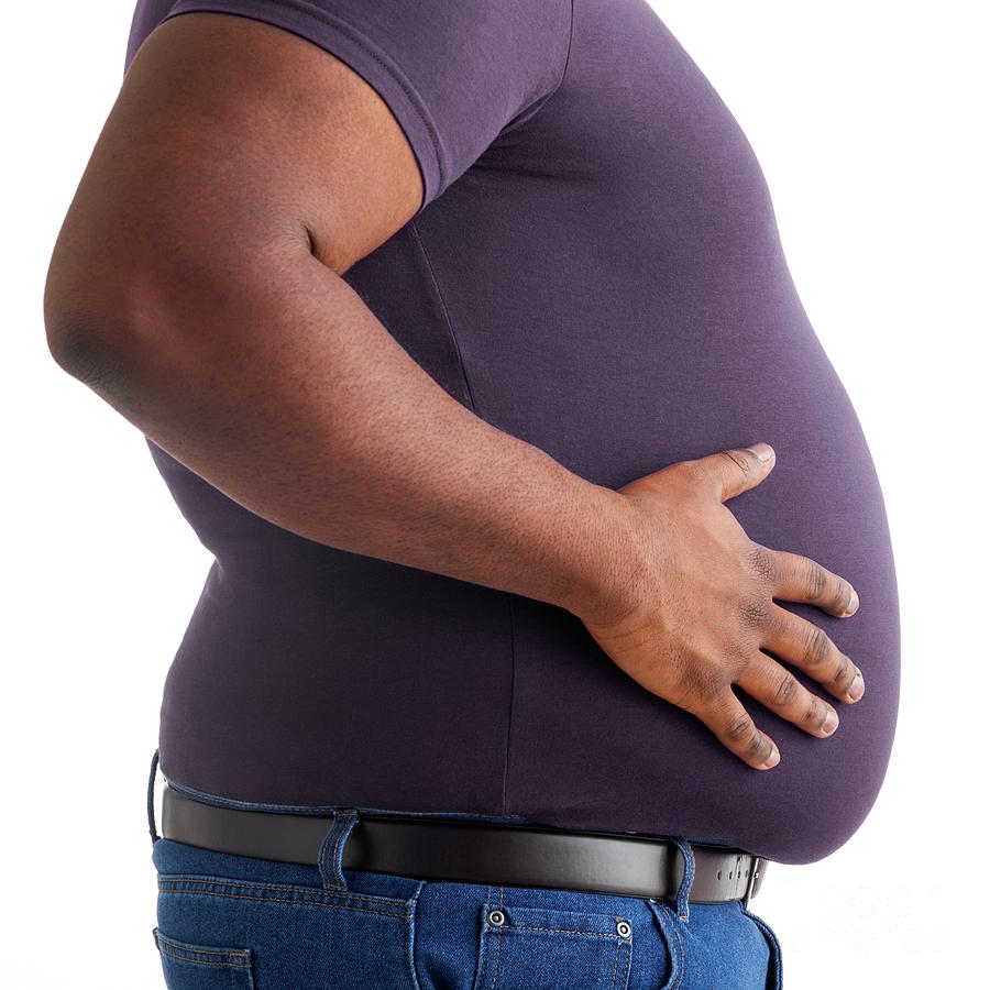 Premium Photo  The overweight and bulky man held his stomach with his  hands and squeezed the fat.