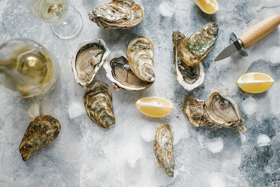 Oysters, Partially Opened, With Lemon Slices And Champagne top View Photograph by Kuzmin5d